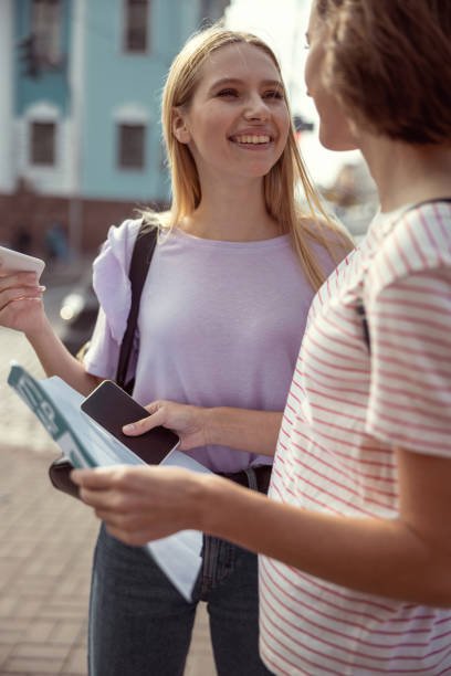 istock Cute girl having pleasant conversation with her friend 1186547152