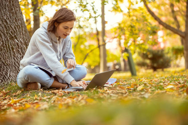 istock Positive delighted young woman working at computer 1186547217
