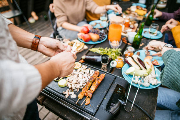 istock Preparing food at party on electric grill 1186549178