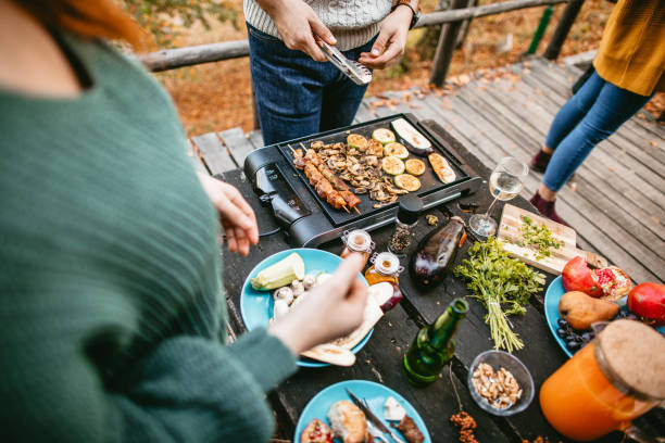 istock Preparing food at party on electric grill 1186549310