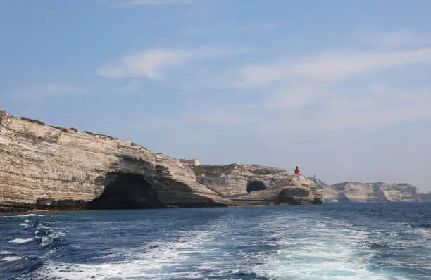 seascape of MediterraneaN Sea and the small red lighthouse near Bonifacio Town in Corsica