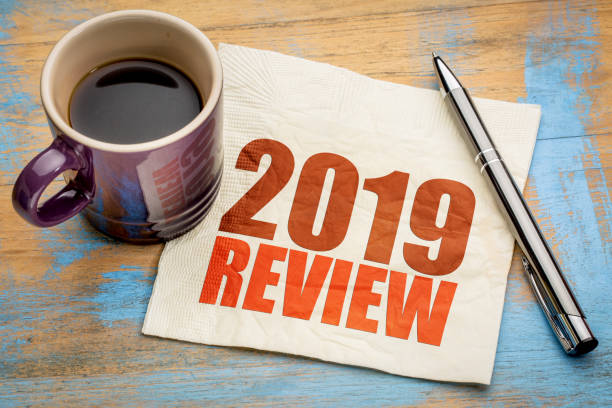 2019 year review on napkin 2019 year review text on a napkin with a cup of coffee, end of year business concept 2019 photos stock pictures, royalty-free photos & images