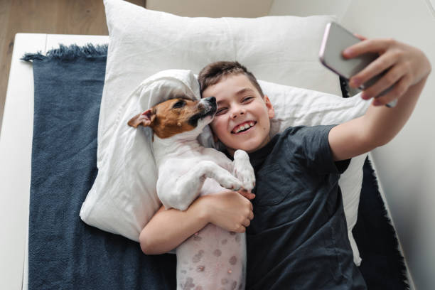 A young boy with a dog in a cozy interior.
