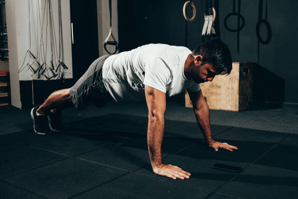 istock Strong man doing pushups at the gym. Calisthenics, bodyweight training 1186562697
