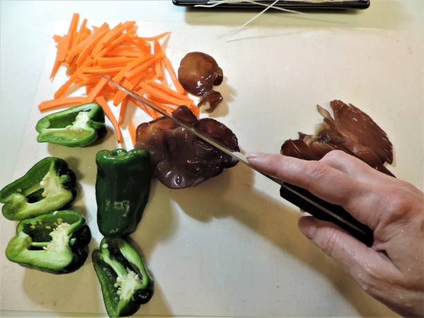Woman hand cutting vegetables and jelly ears for stir fry