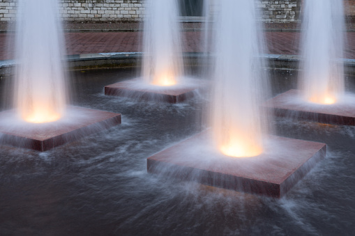 Four illuminated fountains in medieval city Middelburg, The Netherlands
