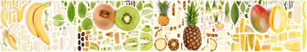 Large collection of tropical fruit pieces, slices and leaves isolated on white background. Top view. Seamless abstract pattern.