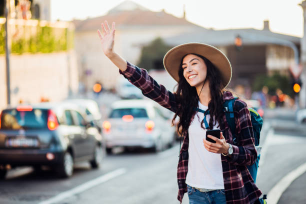istock Female tourist hitchhiking 1186572230