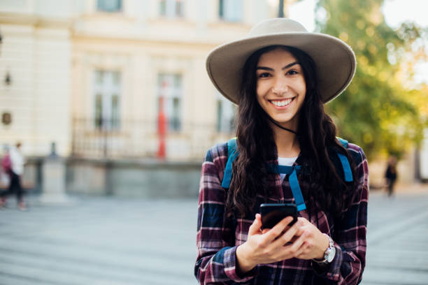 istock Beautiful girl on a journey using smartphone 1186572232
