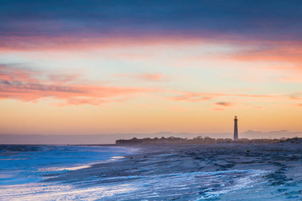 Cape May NJ lighthouse and Atlantic Ocean at sunset in springtime stock photo