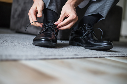 Businessman tie shoelaces