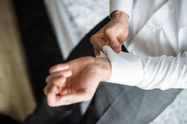 istock Groom putting cuff-links on his shirt sleeve 1186576337
