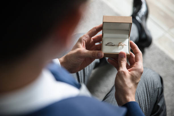 istock Man holding a box with wedding rings 1186576480