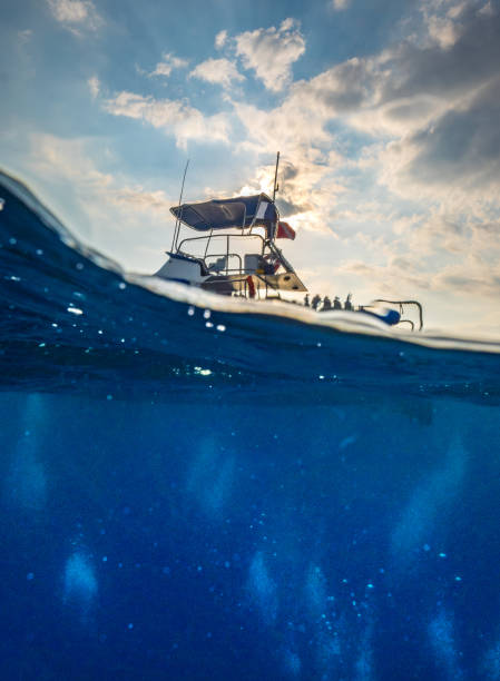 istock Under over image of a small ship in the ocean 1186576536