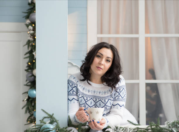 istock young woman over christmas interior background 1186577614