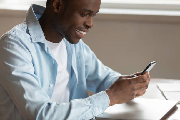 istock Smiling biracial man have pleasant chat on cellphone 1186579695