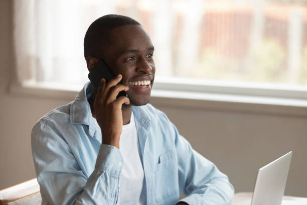 istock Smiling biracial man laugh having cellphone call 1186579696
