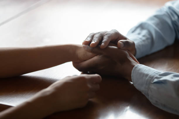 istock Close up of biracial couple hold hands having romantic moment 1186579708