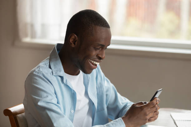 istock Overjoyed biracial man feel euphoric texting on smartphone 1186579711