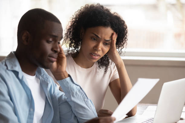 Frustrated biracial couple feel disappointed with financial problems
