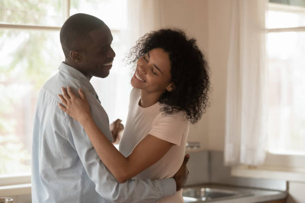 istock Loving biracial couple dance in kitchen celebrating anniversary 1186579736