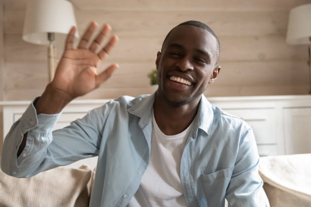 istock Smiling african American man wave having video call 1186579747
