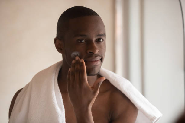 istock Young biracial man apply face cream after shower 1186579761
