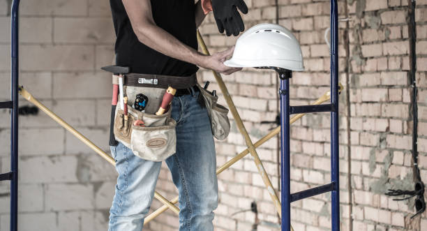 istock Builder handyman with construction tools. House and house renovation concept. 1186581555