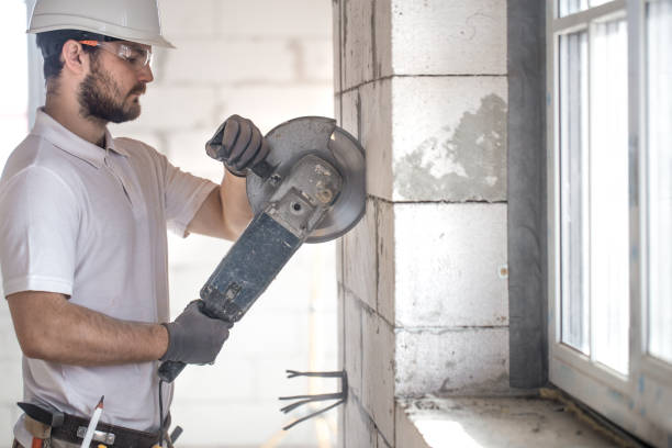 istock The industrial Builder works with a professional angle grinder to cut bricks and build interior walls. Electrician. 1186581566