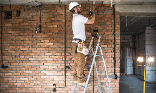istock Electrician with tools, working on a construction site. Repair and handyman concept. 1186581585