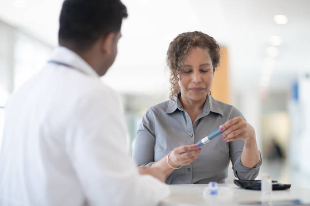 istock Doctor Explaining Diabetic Testing to a Senior Patient stock photo 1186584596