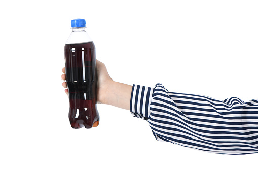 Child drinking Cola from bottle. On white background. High resolution photo. Full depth of field.