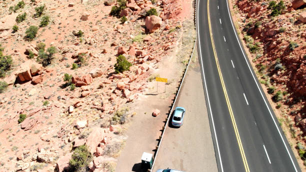 istock Drone view of orange mountain landscape covered with sparse vegetation and curved road creating beautiful scenario of a National Park 1186588024
