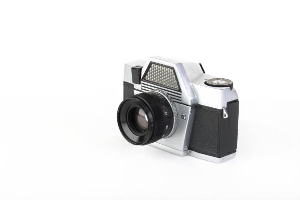 istock The old 35 mm film camera with lens, on white background. 1186589659