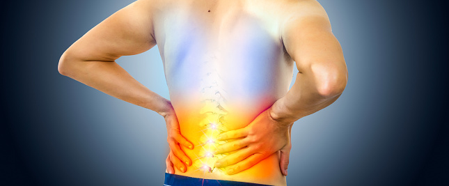 Lower back pain. Man holding his back in pain. Medical concept.