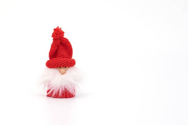 istock Miniature gnome Santa in red hat and with fluffy beard isolated on white 1186591924