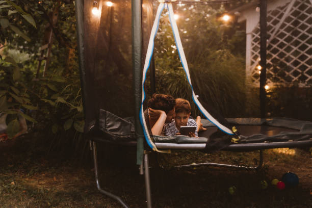 istock Watching cartoons together, while lying on a trampoline 1186594522