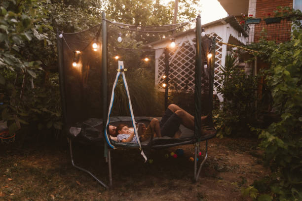 istock Watching cartoons together, while lying on a trampoline 1186594530