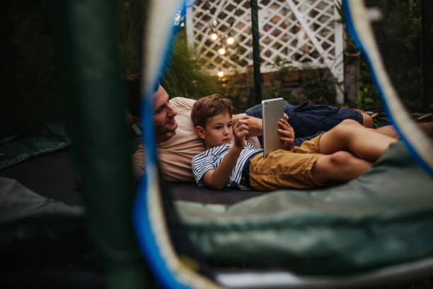 Watching cartoons together, while lying on a trampoline