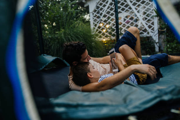 istock Watching cartoons together, while lying on a trampoline 1186595214