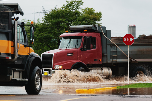 Dump trucks haul sand for flood barriers in Truro, Nova Scotia.