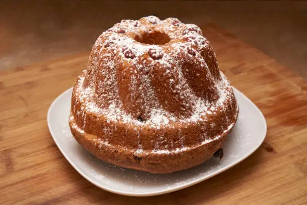 Kugelhopf Cake Powered With Icing Sugar On A Wooden Board Served As A Traditional Dish In Alsace Region France