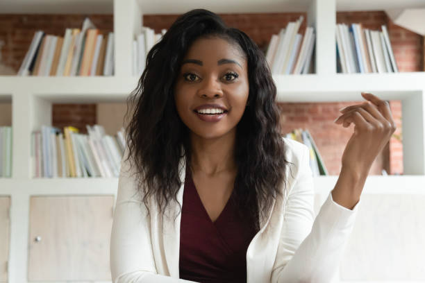 African businesswoman looking at camera make videocall talking with client