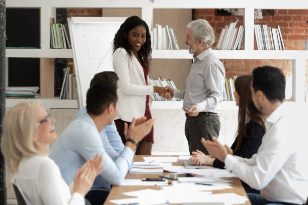 istock Before starting training boss presenting african coach to diverse staff 1186603931