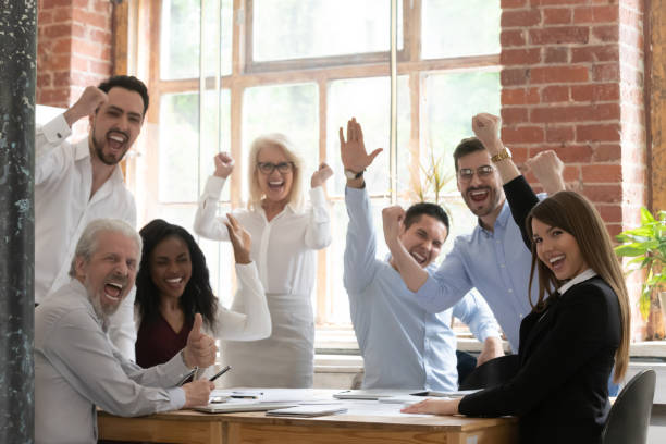 Businesspeople feels excited celebrating succeed business goal Emotional business people multi-ethnic members young and old screaming with joy feels happy succeed business goal, signing important contract, realize worthy project, lucky moment of winners concept cheering group of people success looking at camera stock pictures, royalty-free photos & images