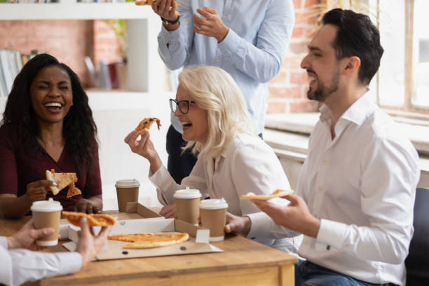 istock Multi racial colleagues eat pizza enjoy break during working day 1186603954