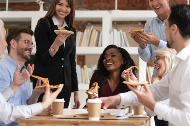 istock Different age ethnicity colleagues eat pizza during lunch at workday 1186603960