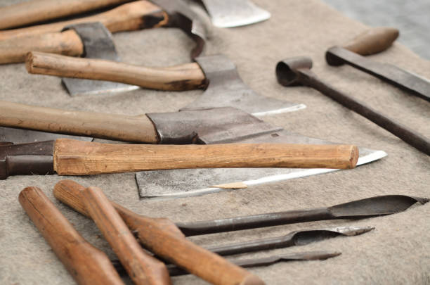 istock Old medieval axes and another tools of carpenter craftsman 1186604103