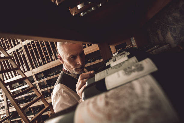 istock Sommelier Concept. Senior man standing choosing wine concentrated close-up 1186604240