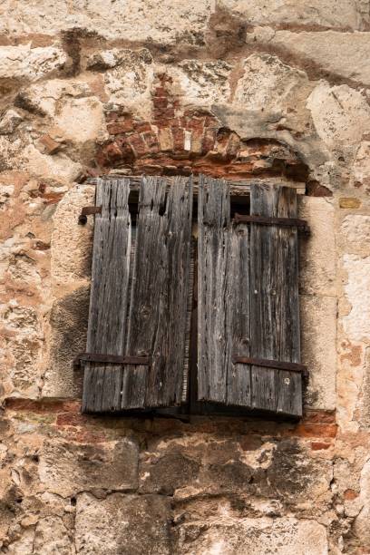istock Old wooden window on a stone house 1186604637